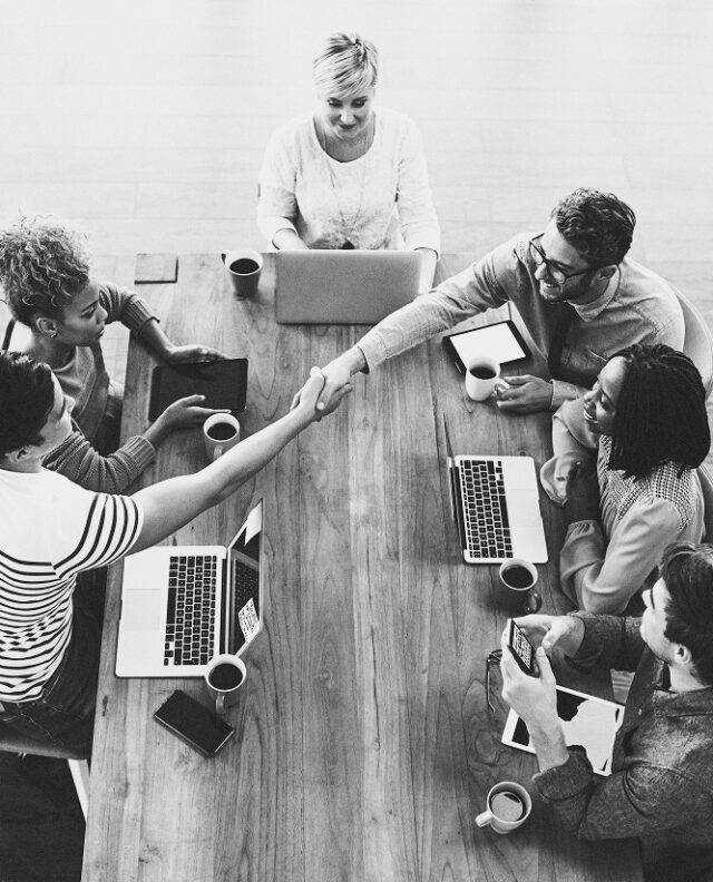 Overhead shot of people sat around a desk